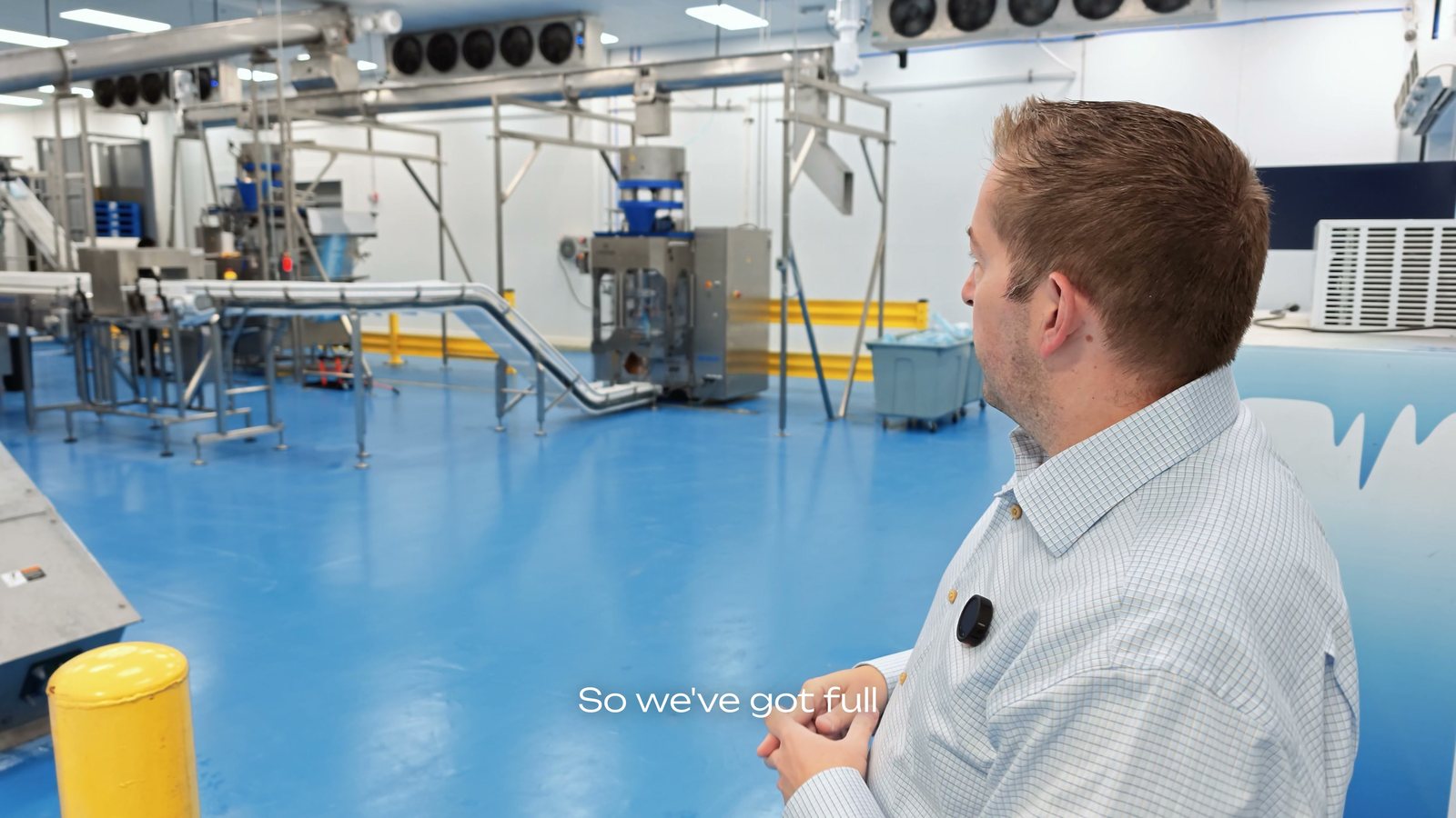 The packaging room at Motor City Ice, with conveyors over a blue floor